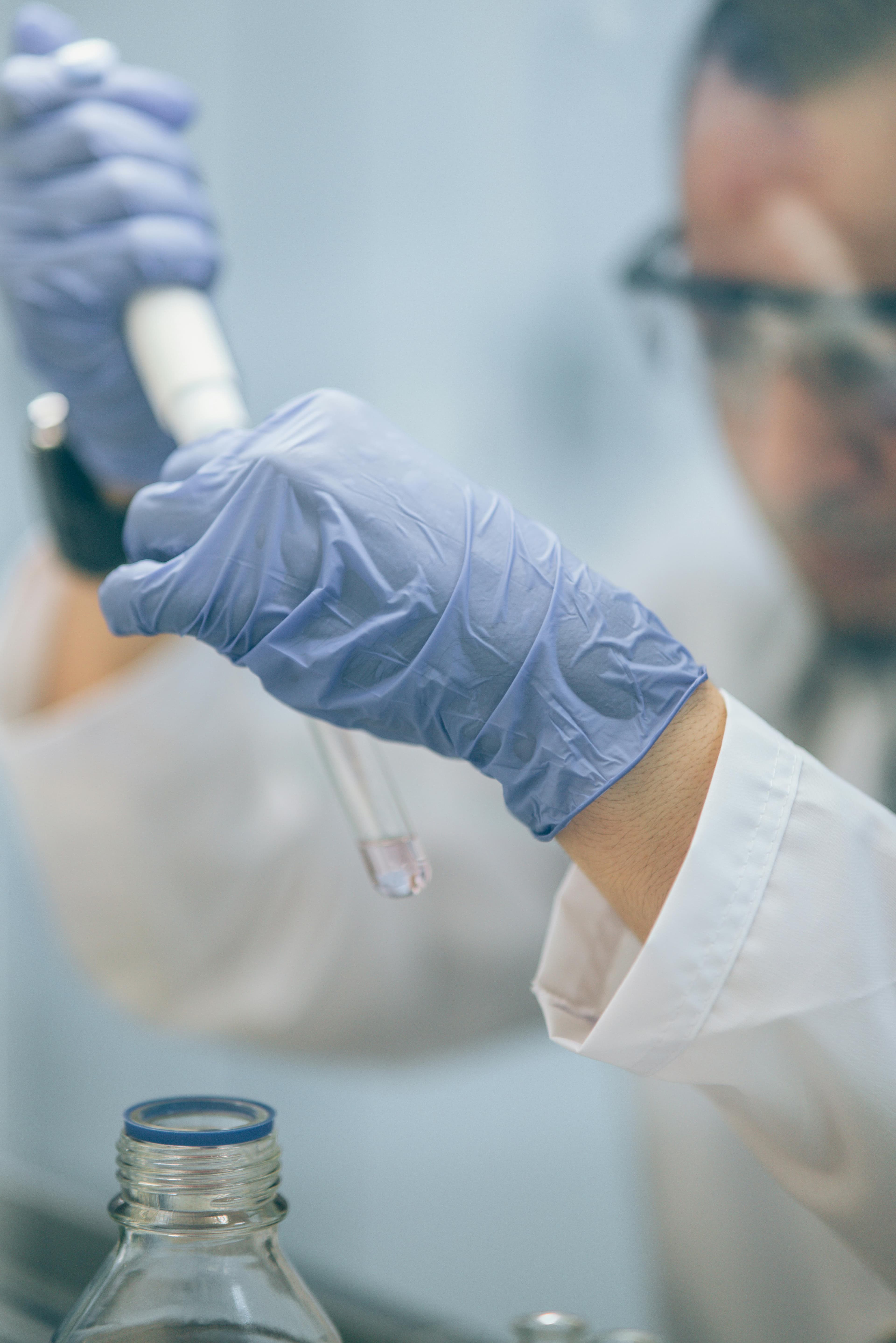 Doctor examining the blood sample to test them and create a report of the Test.